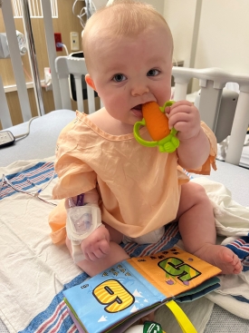 Reece sitting on hospital bed.