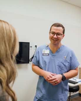 doctor talking with teen patient