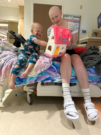 Blakely and Darcie playing with plastic house toy