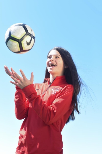 allison tossing soccer ball in the air