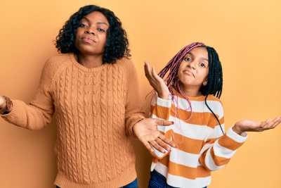 mother and daughter shrugging their shoulders