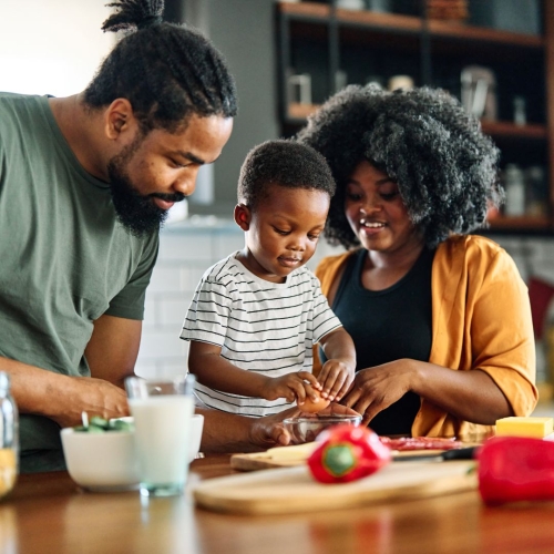 Family cooking with vegetables