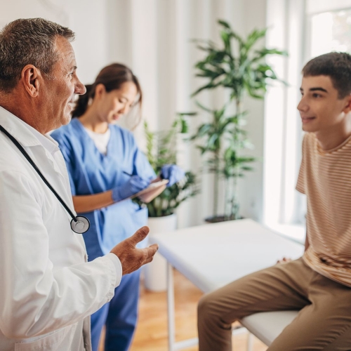 Teen boy talking to doctor