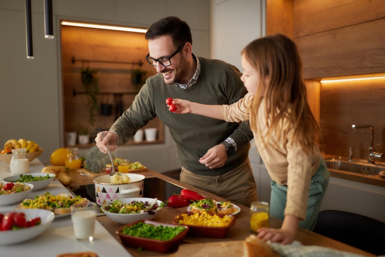 father and daughter cooking together