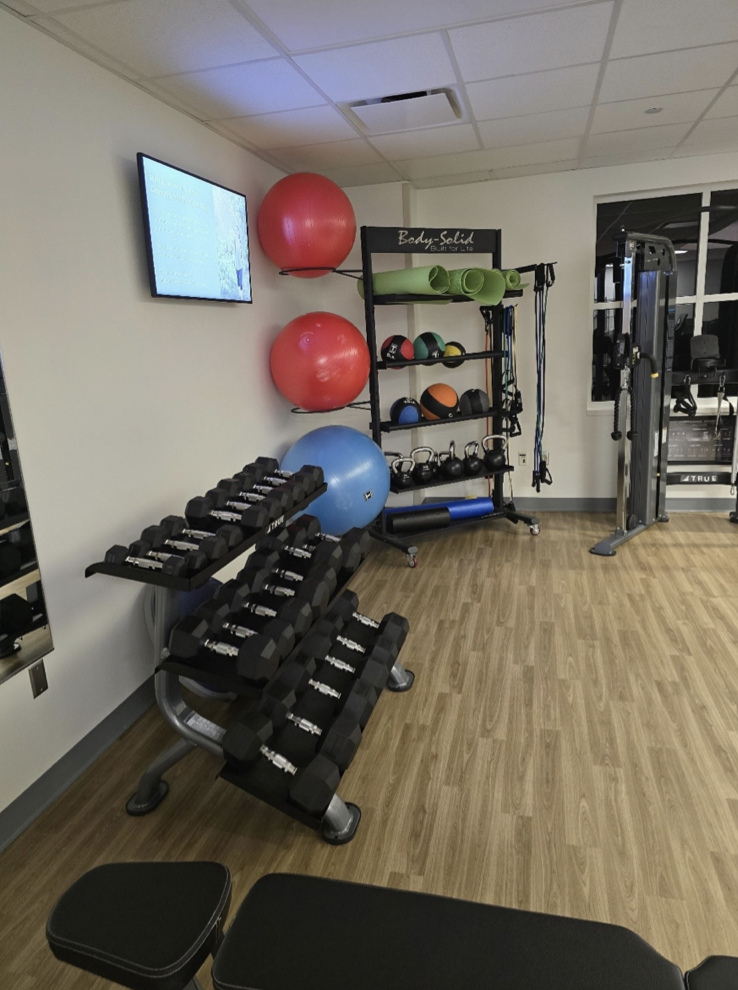 dumbbells and other fitness equipment located in fitness center