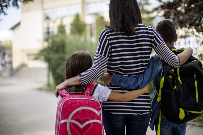 mother and children going to school