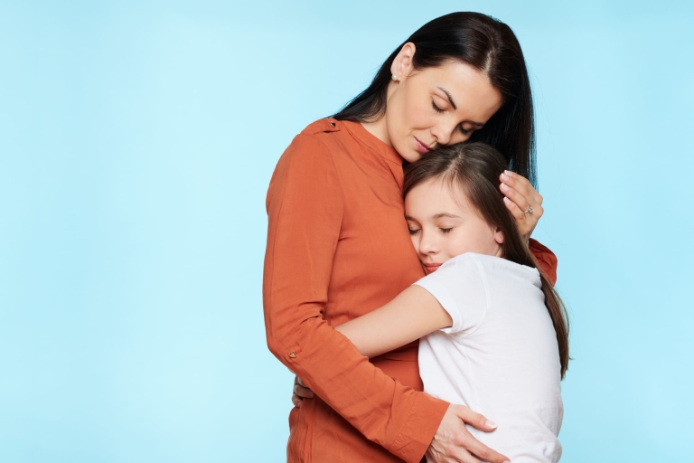 mother comforting sad daughter