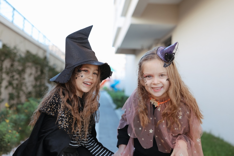 two girls in a witch costume