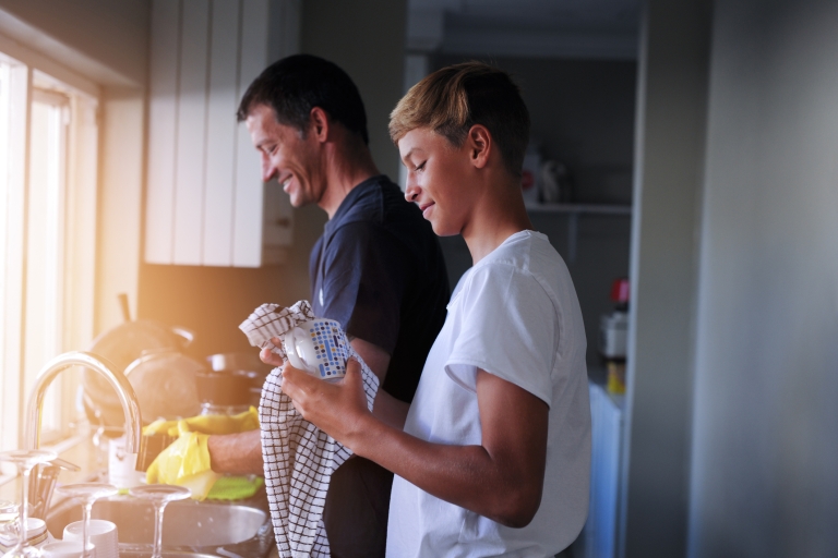 teenage son doing dishes