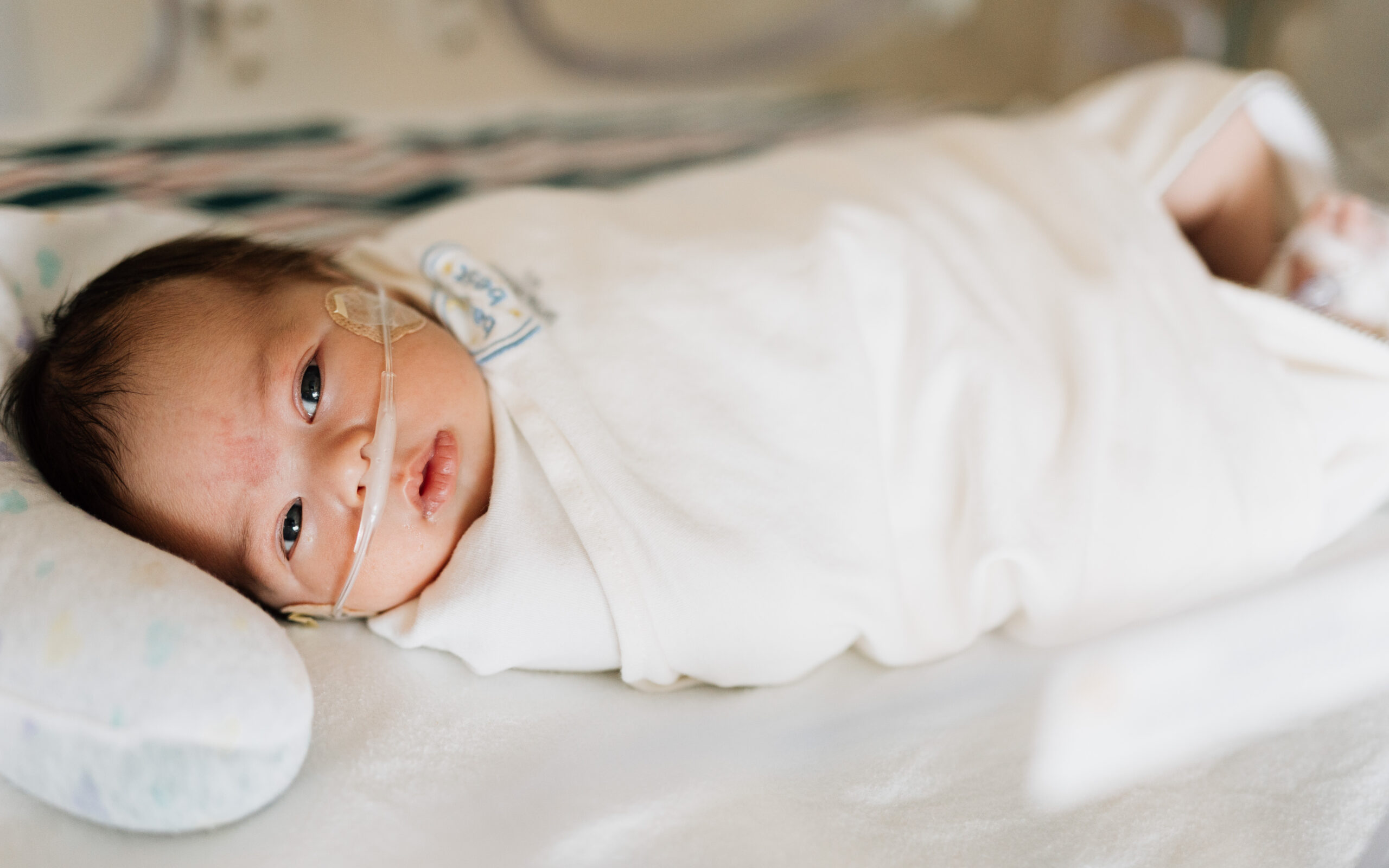 Sleeping infant in a hospital bed representing ways to support families at Dayton Children’s Hospital.