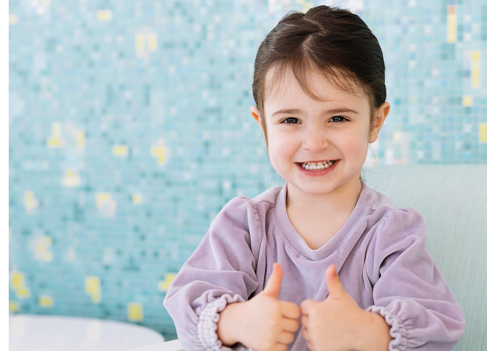 Smiling child giving two thumbs up in support of giving at Dayton Children’s Hospital.