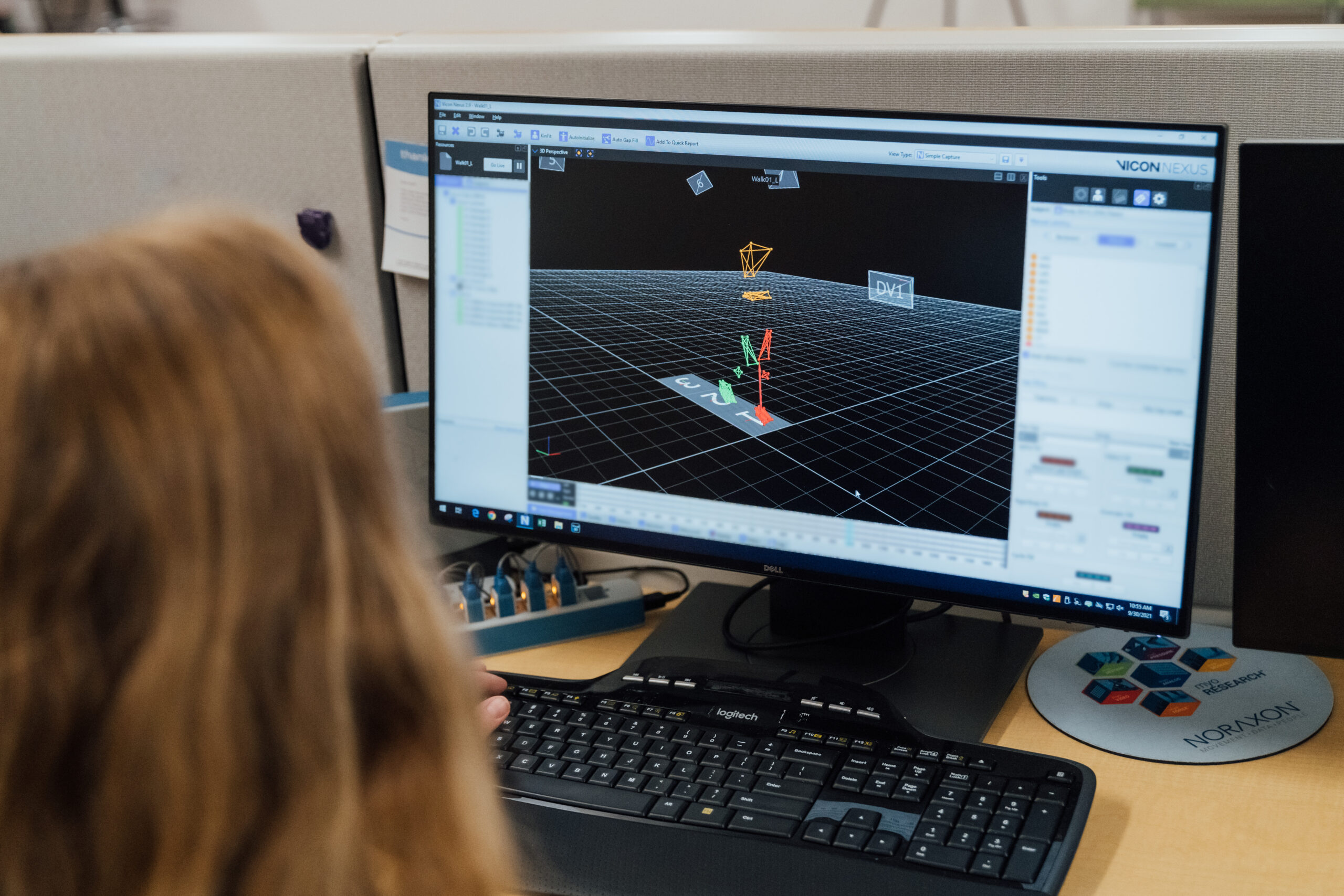 Provider reviewing video on a computer screen of a child's movement as they walk through the gait lab.