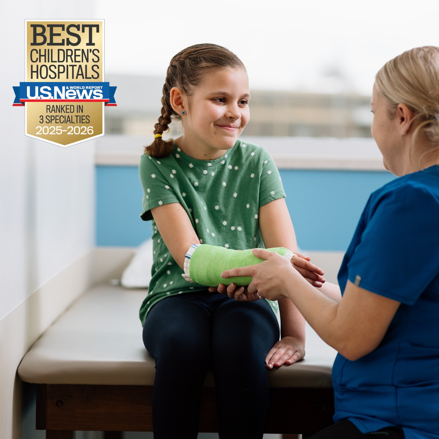 little girl with cast smiles at her care provider at Dayton Children's