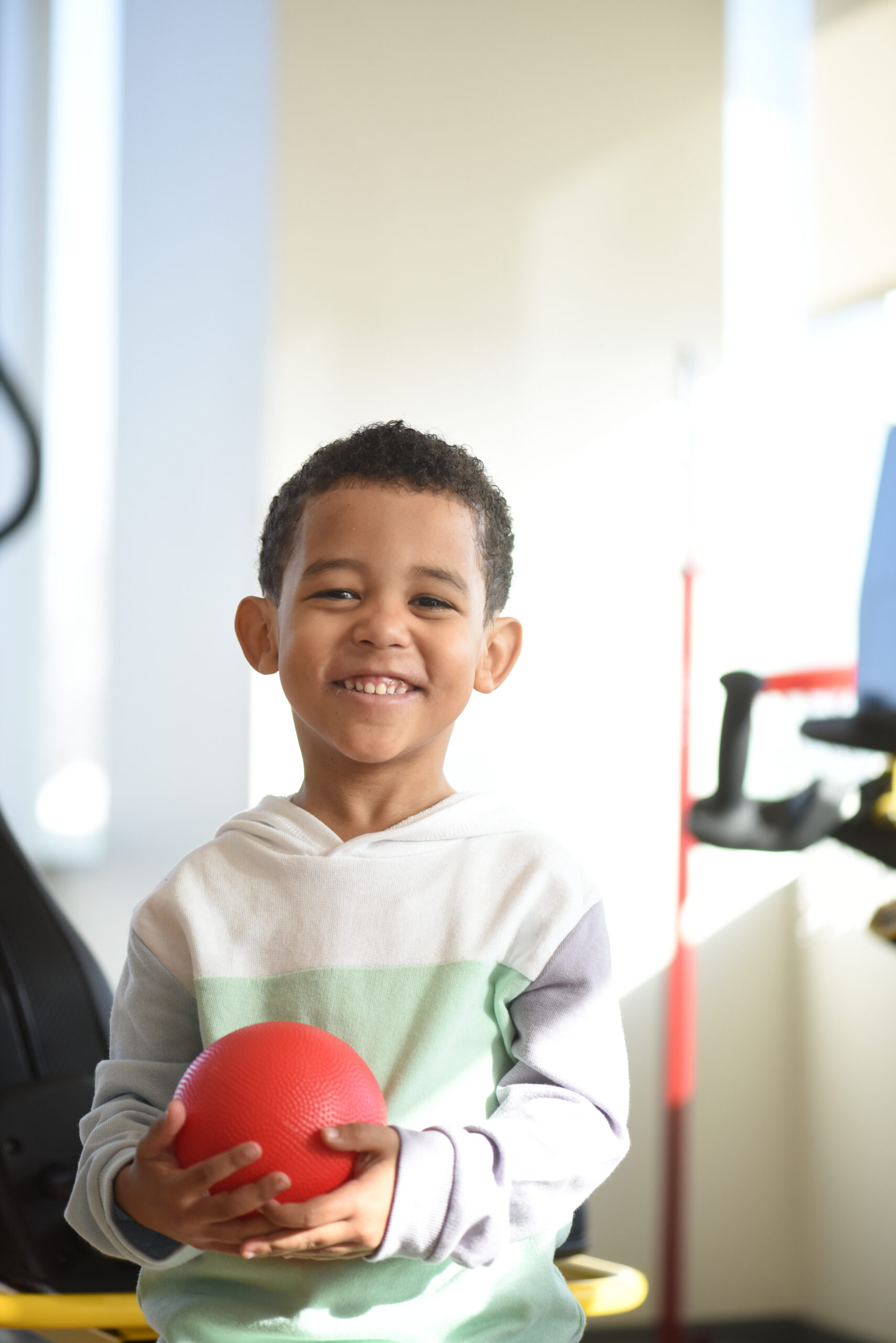 A happy young boy smiling at the camera.


