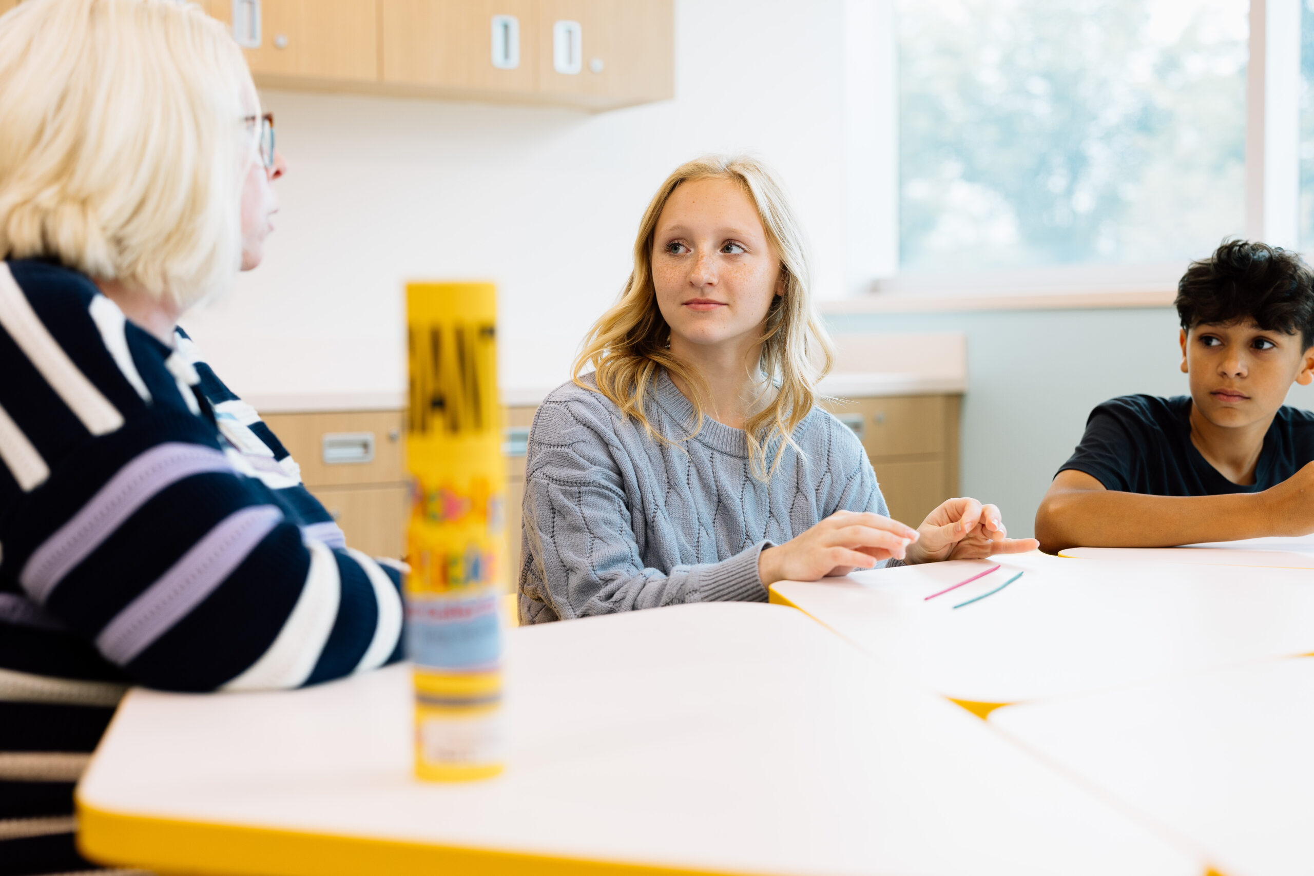  Two teens listening to an art therapist talk about how art can be a great outlet for our emotions.