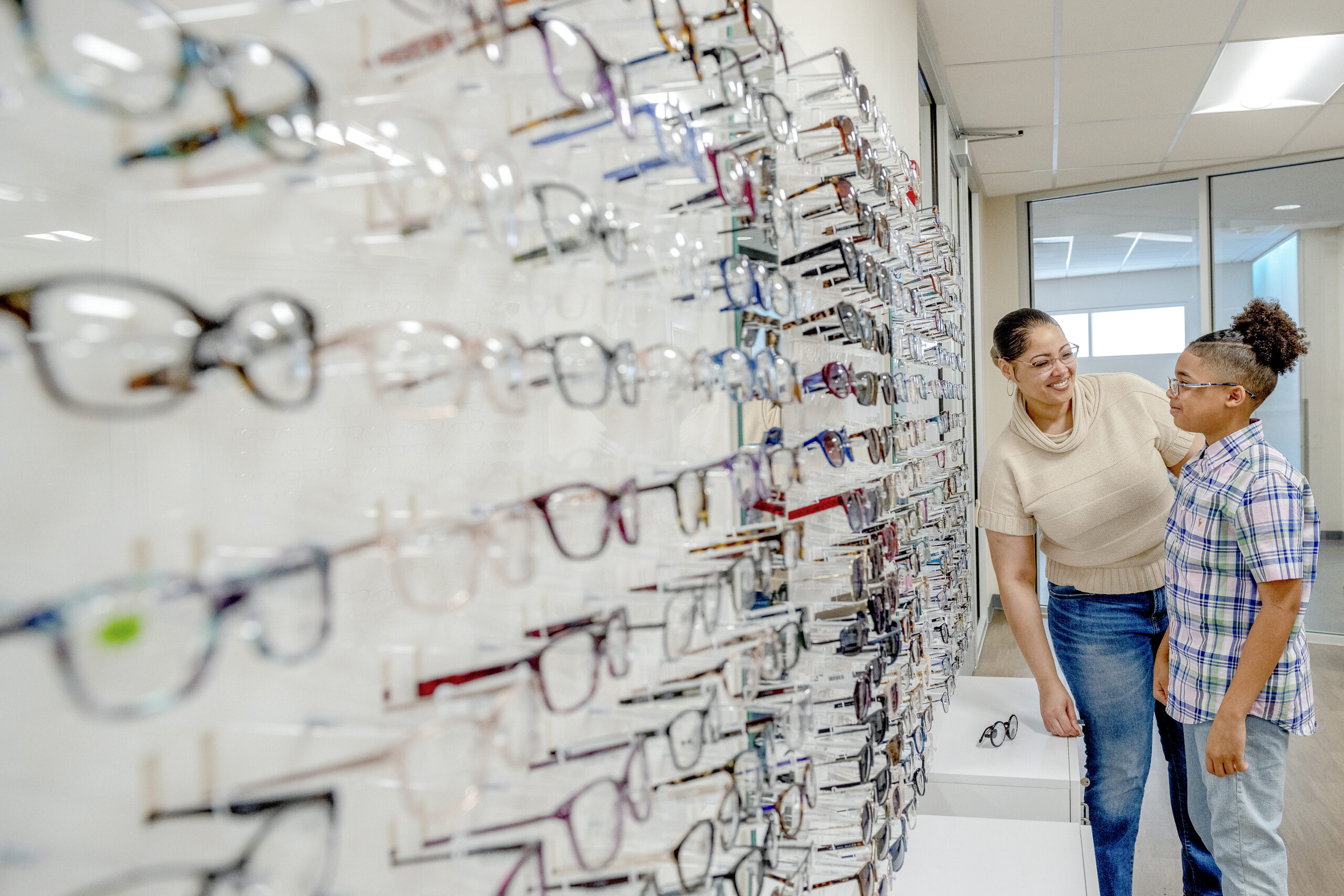 A teen boy and his mom peruse the wide variety of glasses offered in the optical shop at Dayton Children's Hospital.
