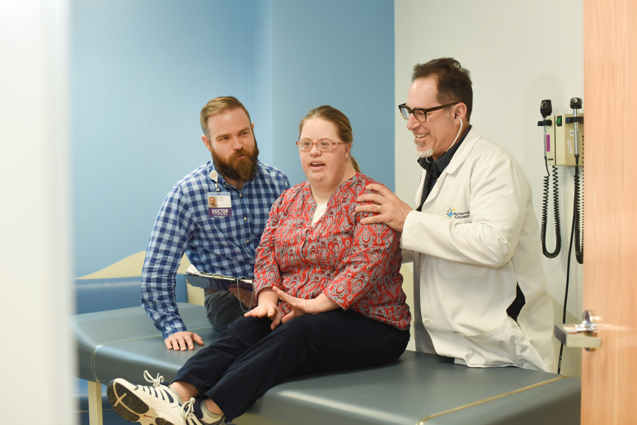 adult with congenital heart disease with 2 doctors in clinic room