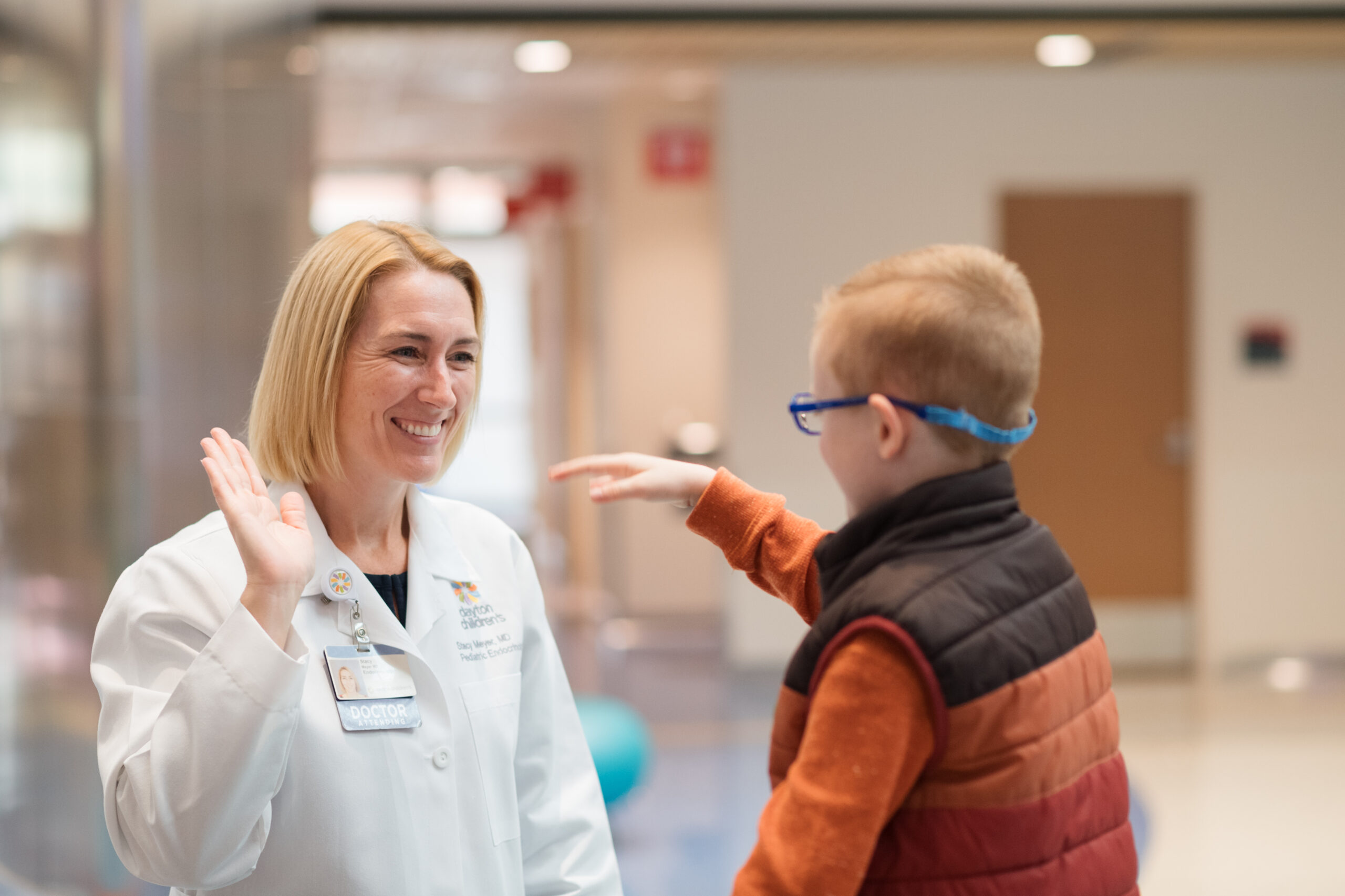 Endocrinology doctor high-fiving a young boy at Dayton Children’s.