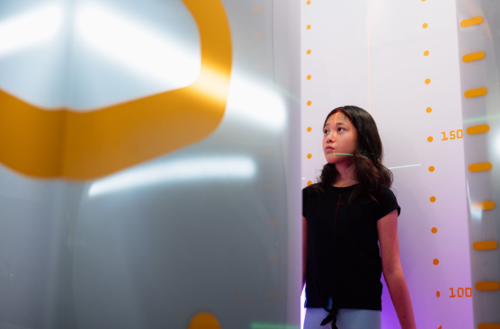 Young girl standing in for images after successful scoliosis treatment.