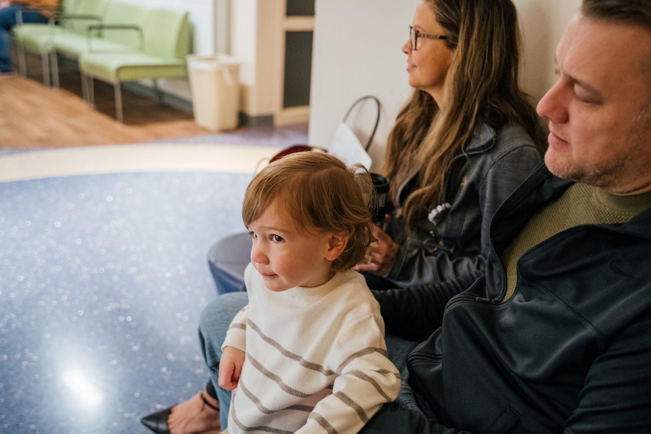 A kid waits with his parents for his appointment with the Dayton Children’s nephrologist.