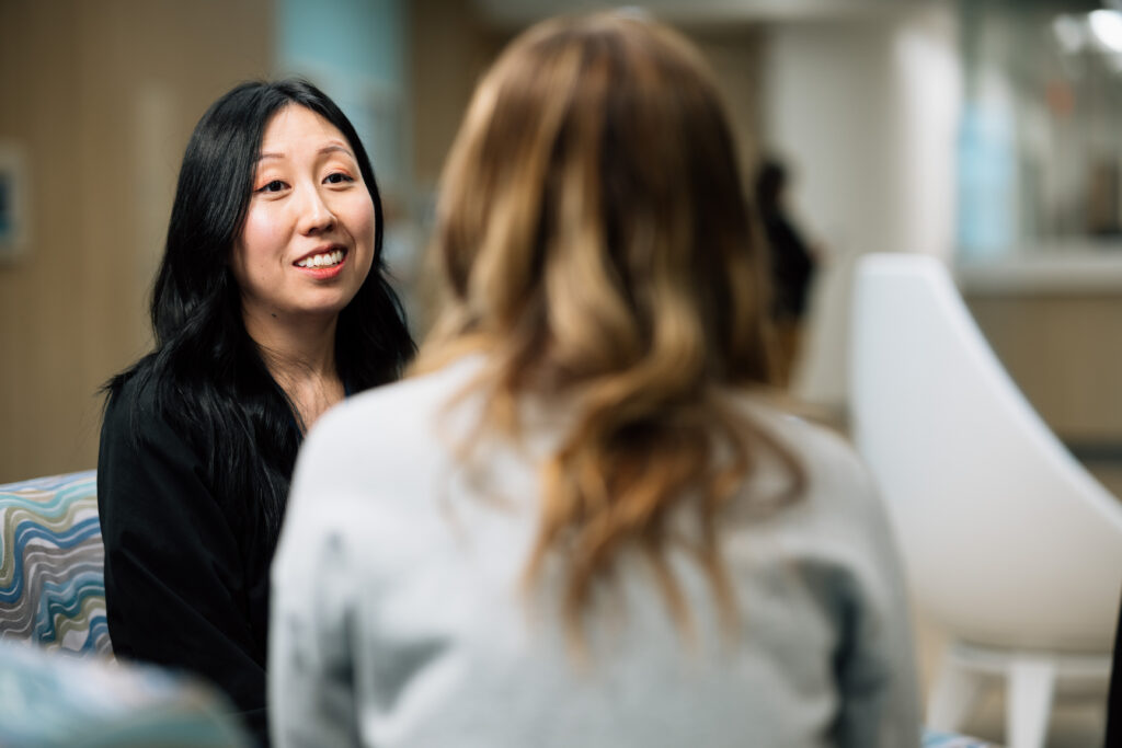 Female mental health specialist actively listens to a patient talk about their thoughts and emotions. 