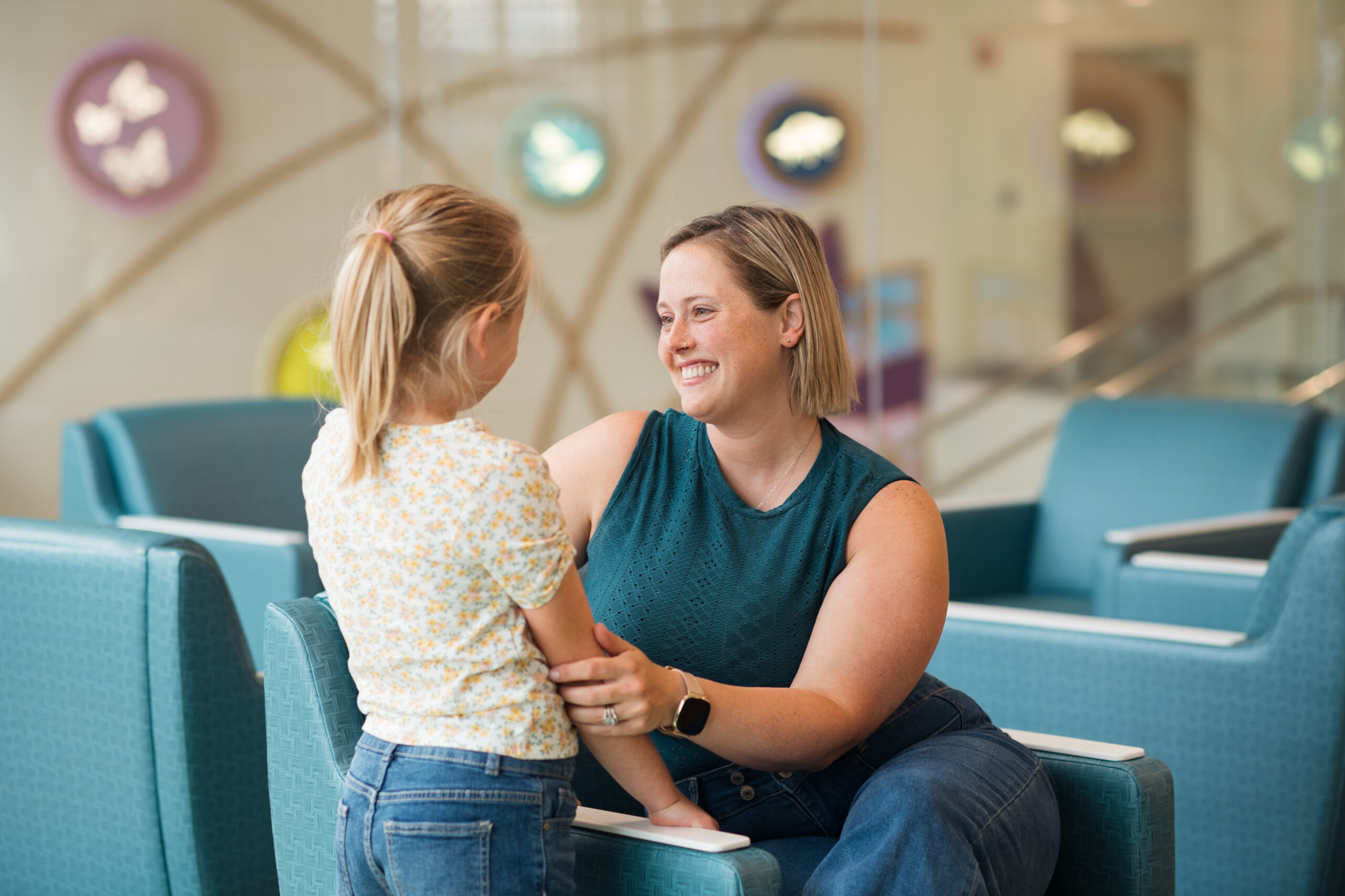 A mother comforts her daughter after a difficult speech therapy session.
