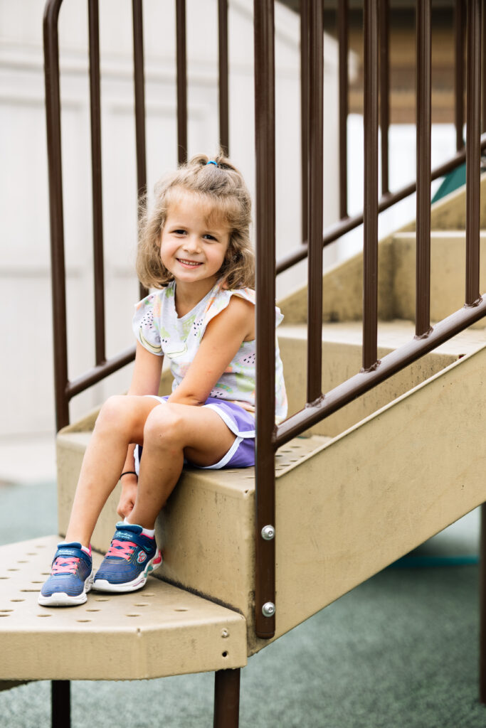 A little girl is hesitant to play with other kids on the playground due to her stutter.