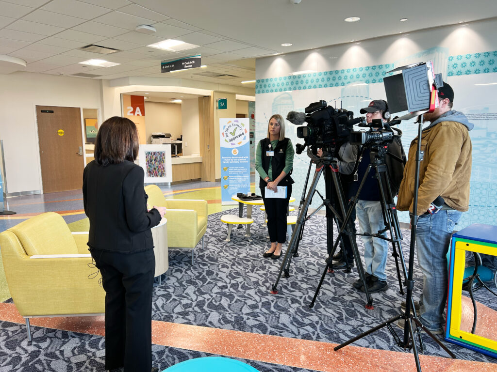 Woman stands in front of cameras at Children's Hospital