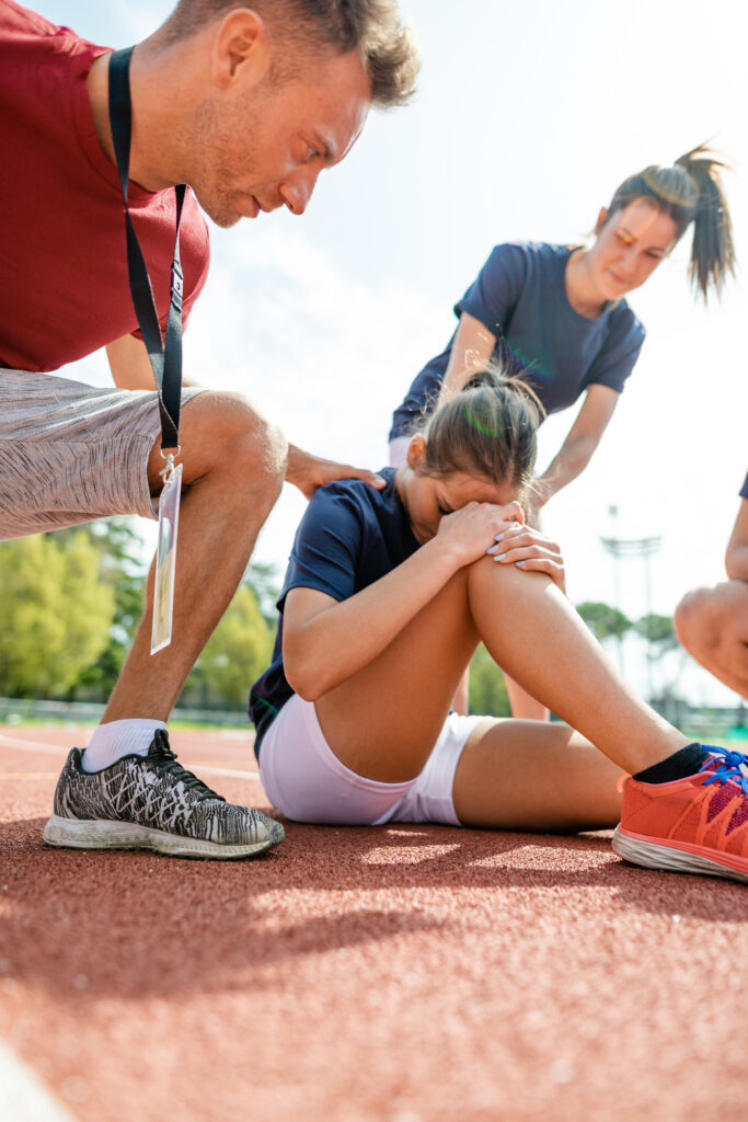 a young woman gets injured playing a sport