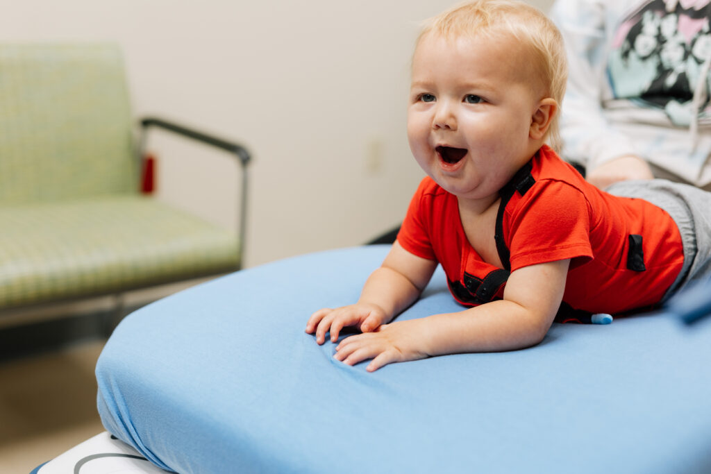 A little baby is in for a visit to determine if he is hitting his developmental goals.
