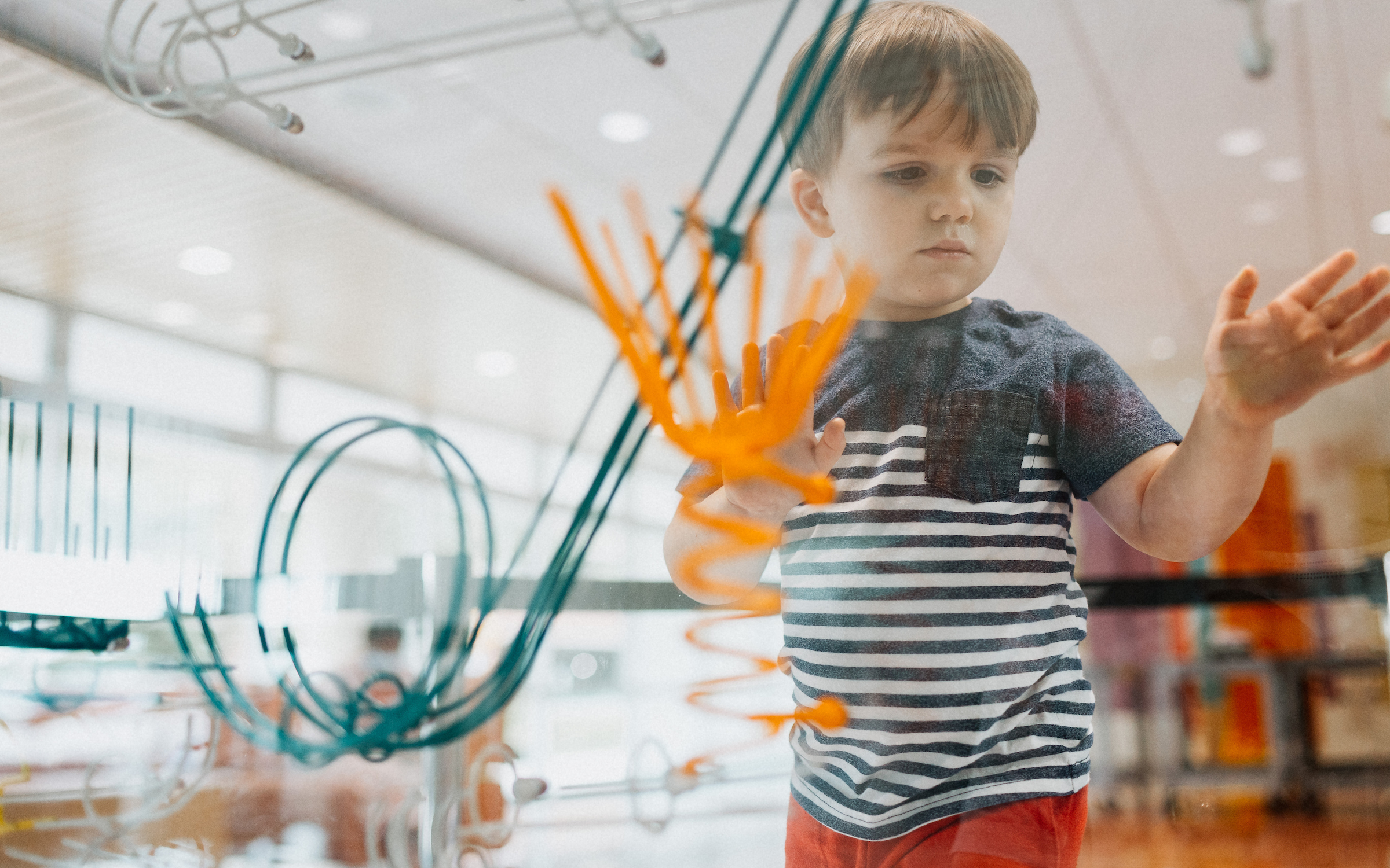A young patient plays with an interactive ball machine for kids while visiting Dayton Children’s.

