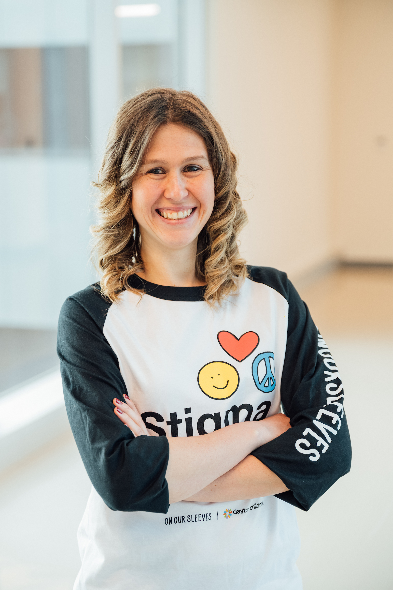 Female adult, Emily smiling to show her support of On Our Sleeves and children’s mental health