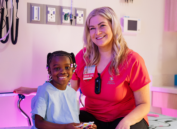 Two people standing together using conversation starters to learn more about a child and open more for deeper conversations.