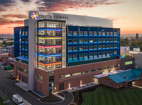 The exterior of a Dayton Children’s hospital building at sunset, representing the organization’s annual growth, performance, and commitment to care.