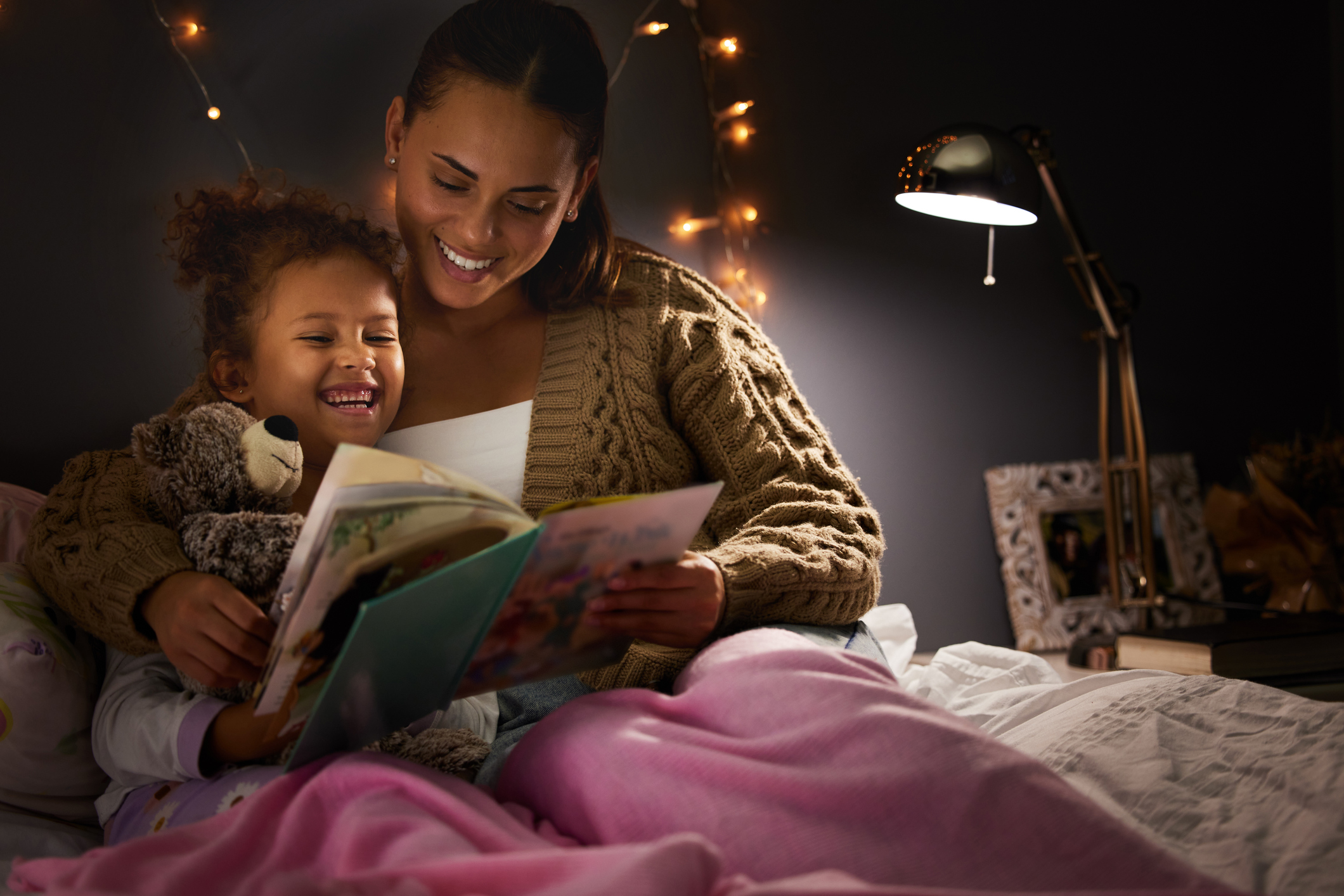Mother reading a bedtime story to her daughter.