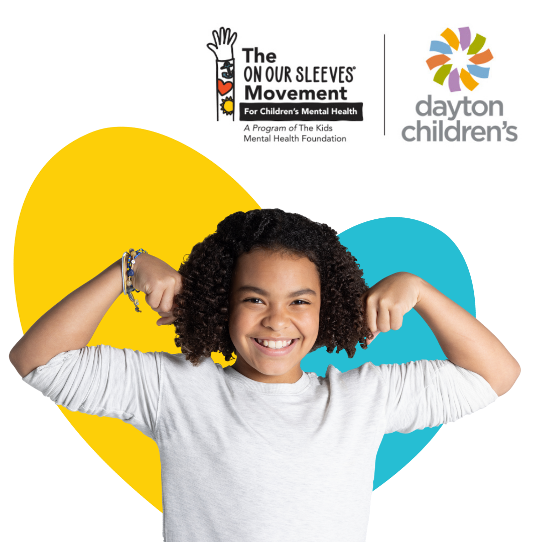 Smiling child flexing arms in front of On Our Sleeves and Dayton Children’s logos, promoting kids’ mental health support.