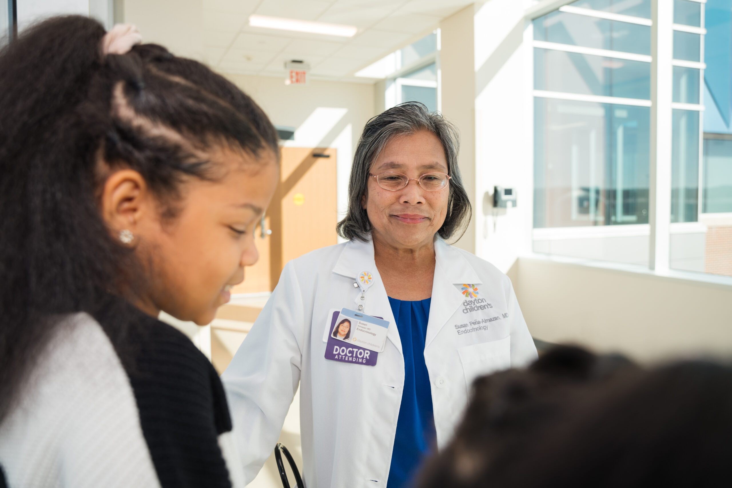 A provider talks to a patient in the hallway after their visit.