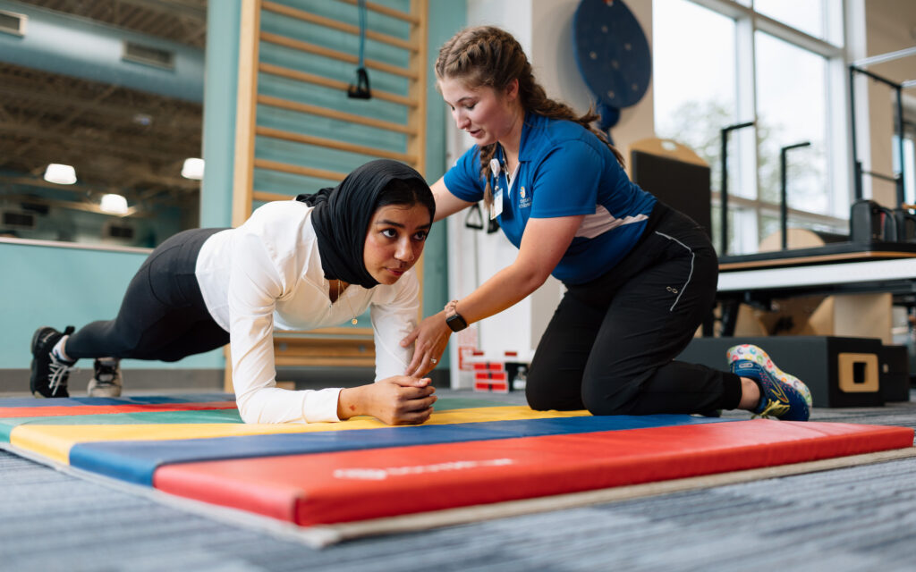Teen female athlete feeling empowered during visit with an athletic trainer at the Center for the Female Athlete.