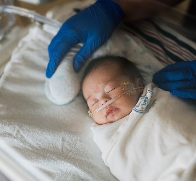 newborn baby swaddled sleeping with oxygen tube in while staying at Dayton Children's Hospital in Ohio