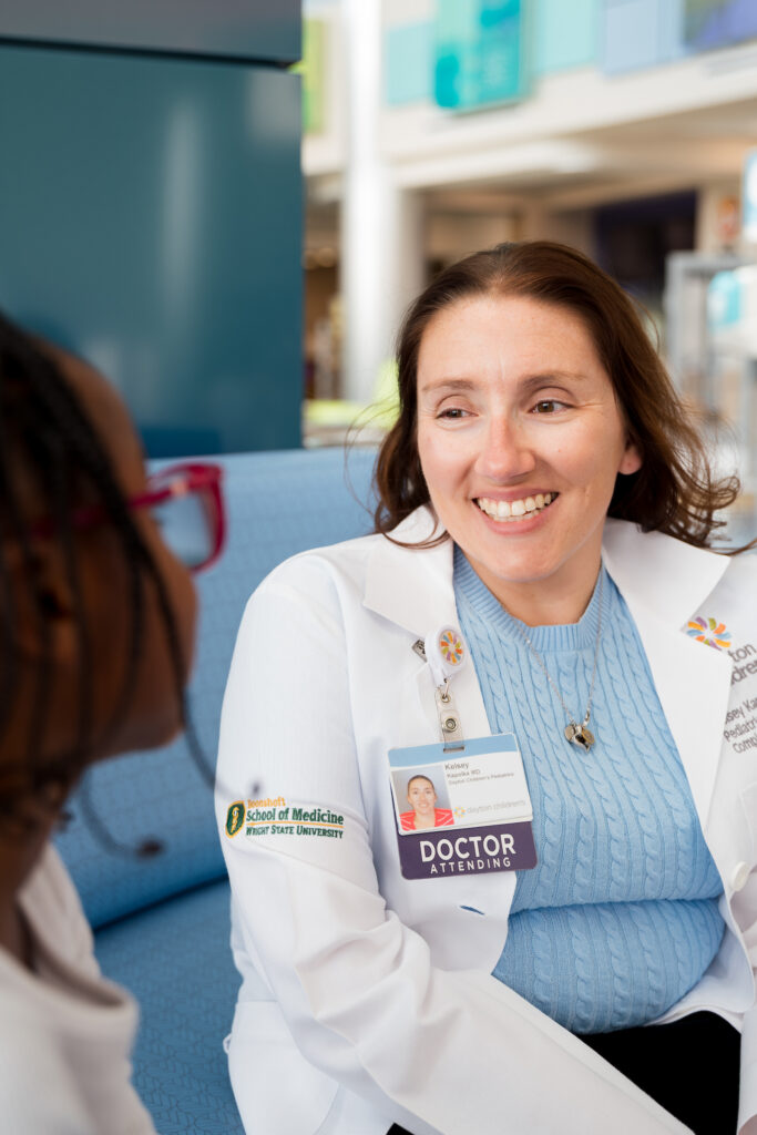 Female pediatrician talking with young patient.