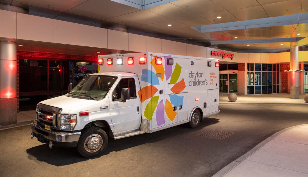 Mobile Intensive Care Unity ambulance parked outside of entrance of Dayton Children’s Level 1 Trauma Center Emergency Department. 