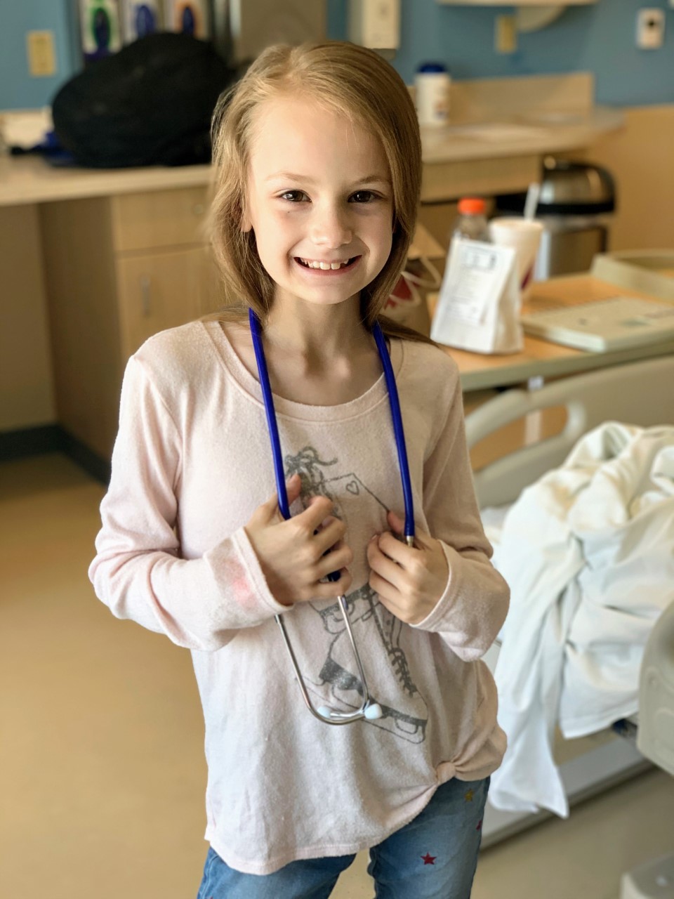 Audrey holds a stethoscope in Dayton Children's Hospital room.