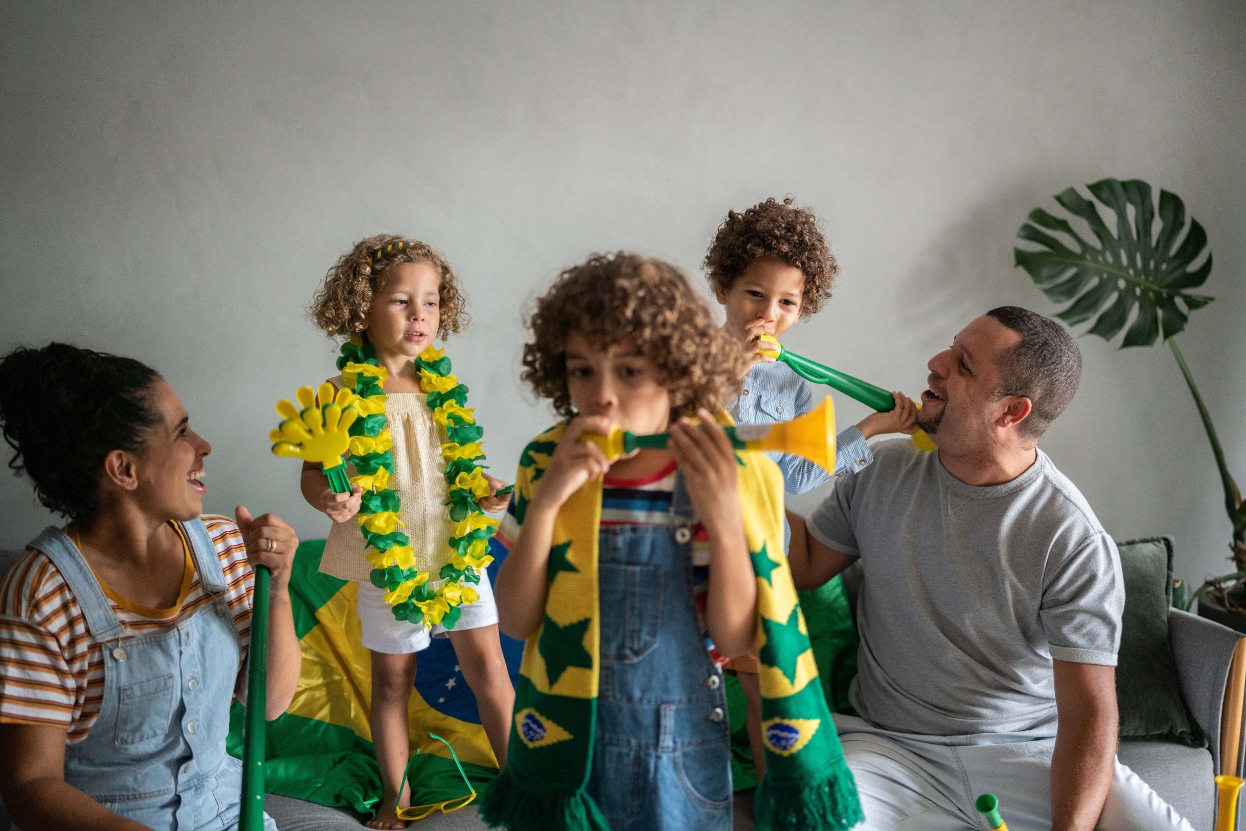Family cheering for sporting event at home