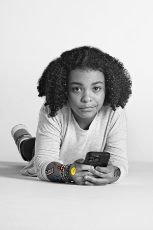 young girl poses with cell phone for On Our Sleeves campaign photo