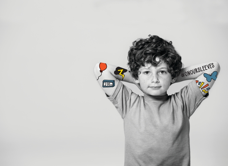 boy poses for On Our Sleeves campaign photo