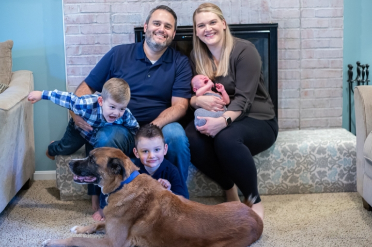 family poses for group photo with family dog
