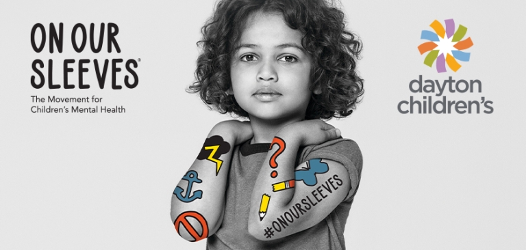 child poses for On Our Sleeves