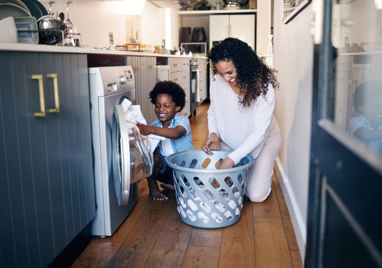 mother and son do laundry to help out around the house