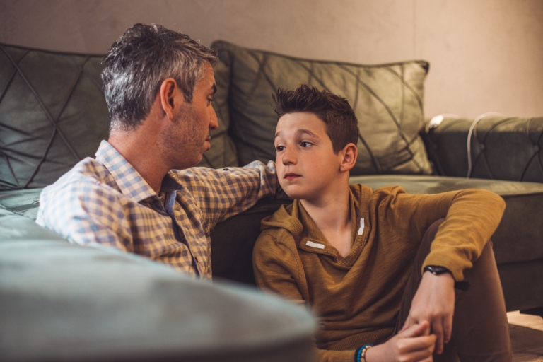 father comforts son who is experiencing anxiety