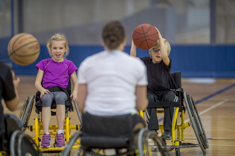 young children playing wheelchair basketball